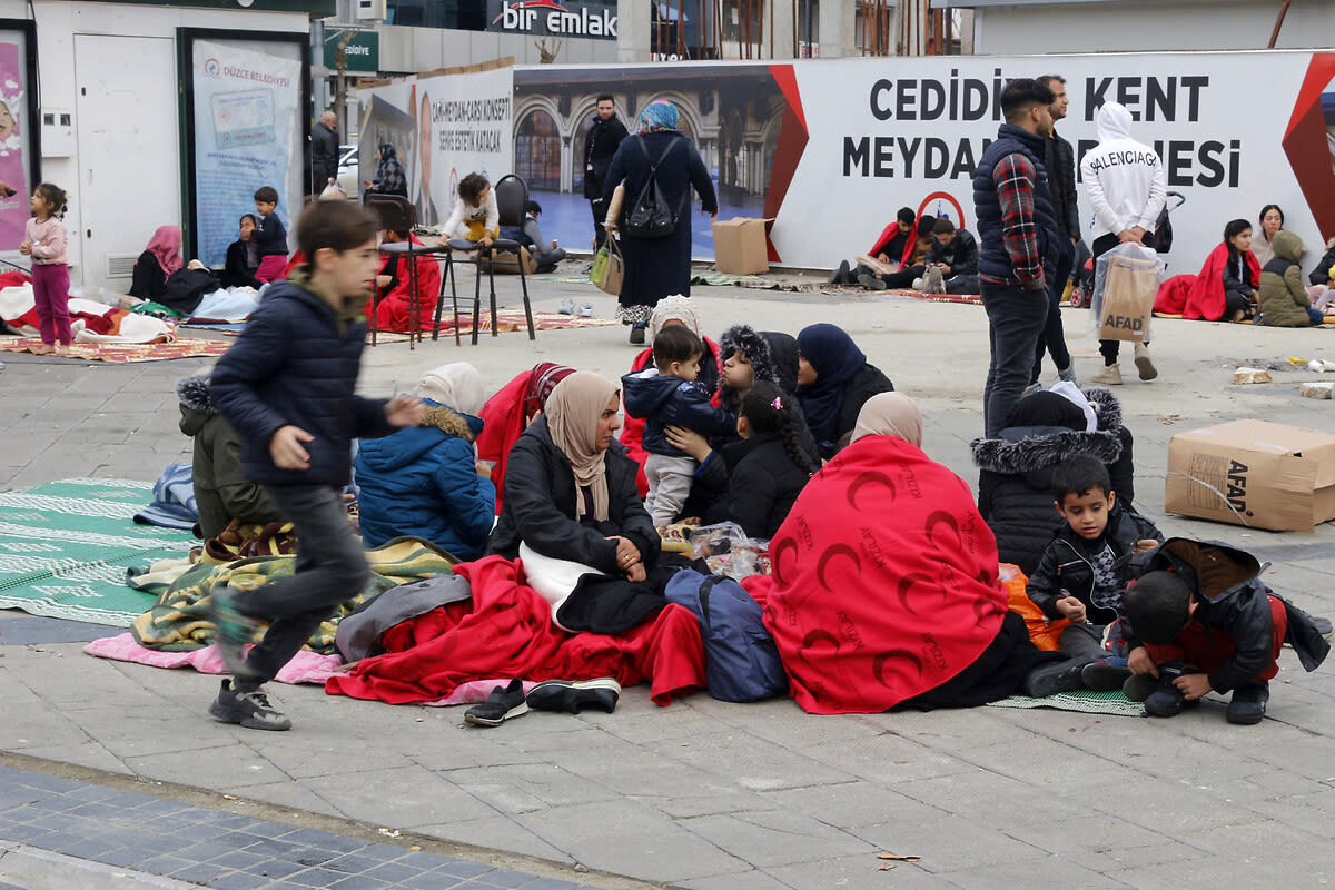 People rest outside their homes in Duzce, Turkey, Wednesday, Nov. 23, 2022, after a magnitude 5.9 earthquake hit a town in northwest Turkey early Wednesday, causing damage to some buildings and widespread panic. Around 50 people were injured, mostly while trying to flee homes. The earthquake was centered in the town of Golkaya, in Duzce province, some 200 kilometers (125 miles) east of Istanbul, the Disaster and Emergency Management Presidency said. (Depo Photos via AP)