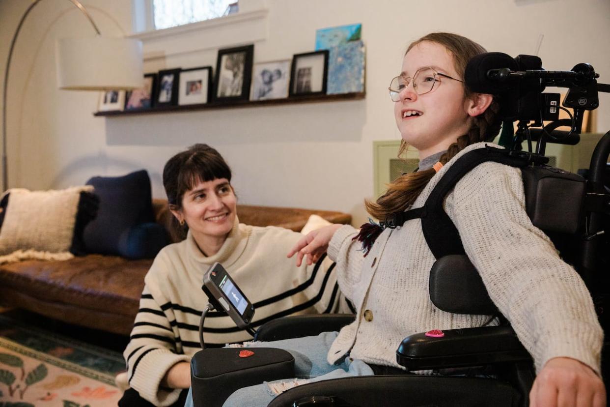 Hilary Thomson and her daughter, Cora, at their home in Vancouver. Cora is in Grade 5 and has cerebral palsy. Thomson says there have been times this year when a shortage of trained support workers at Cora's school has been an issue. (Gian Paolo Mendoza/CBC - image credit)