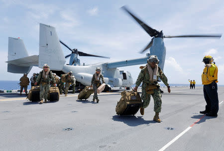 U.S. Marines Corps haul their gear out of a MV-22B Osprey that evacuated them to the USS Kearsarge aircraft carrier as U.S. military continues to leave the U.S. Virgin Islands in advance of Hurricane Maria, in the Caribbean Sea near the islands September 17, 2017. Picture taken on September 17, 2017. REUTERS/Jonathan Drake