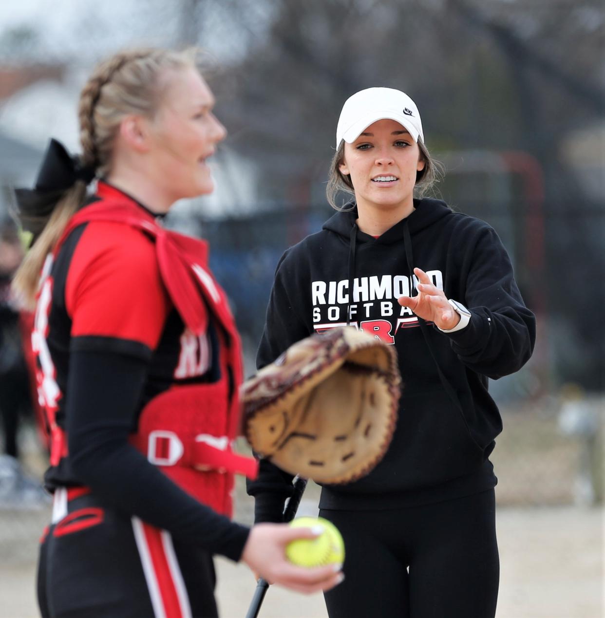 Richmond head coach Alexis Cox hits grounders to her infielders before a scrimmage against Adams Central March 21, 2023.