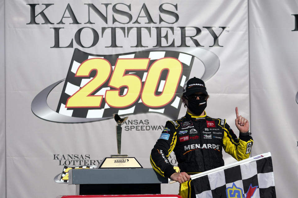 Brandon Jones celebrates after winning a NASCAR Xfinity Series auto race at Kansas Speedway in Kansas City, Kan., Saturday, July 25, 2020. (AP Photo/Charlie Riedel)