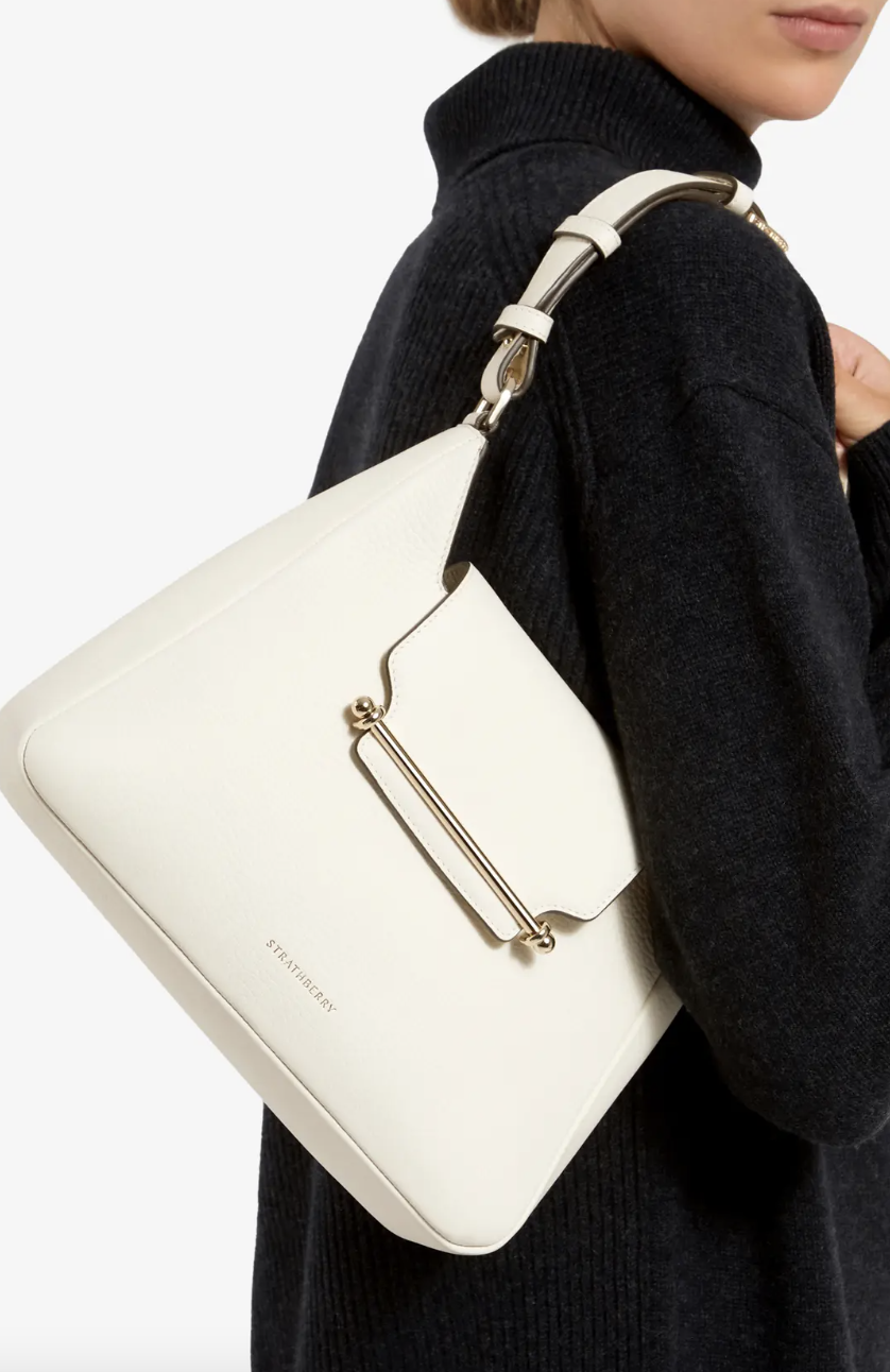 woman wearing black sweater and white Strathberry Multrees Leather Hobo (Photo via Nordstrom)