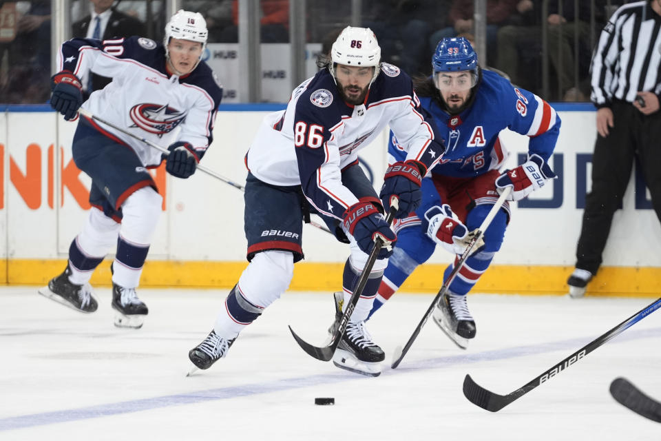 Columbus Blue Jackets' Jack Roslovic (96) drives past New York Rangers' Mika Zibanejad (93) as Blue Jackets' Dmitri Voronkov (10) watches during the second period of an NHL hockey game Wednesday, Feb. 28, 2024, in New York. (AP Photo/Frank Franklin II)