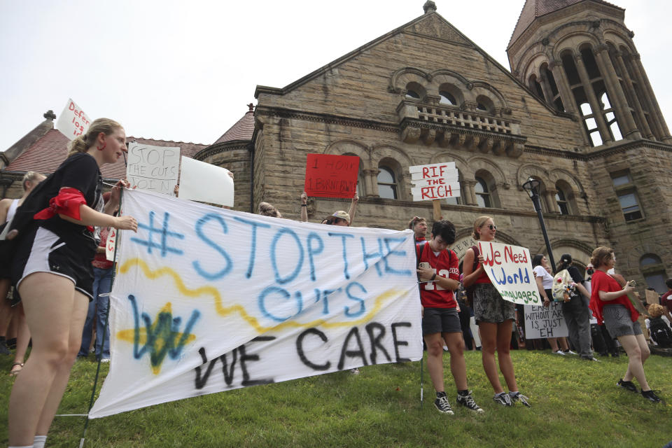 FILE - West Virginia University students lead a protest against cuts to programs in world languages, creative writing and more amid a $45 million budget deficit outside Stewart Hall in Morgantown, W.Va., on Monday, Aug. 21, 2023. West Virginia University is recommending slashing its language department and dozens of other programs amid a $45 million budget shortfall. (AP Photo/Leah Willingham, File)