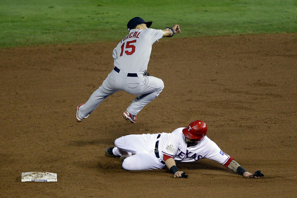 ARLINGTON, TX - OCTOBER 23: Rafael Furcal #15 of the St. Louis Cardinals turns the double play as Mike Napoli #25 of the Texas Rangers slides into second base in the eighth inning during Game Four of the MLB World Series at Rangers Ballpark in Arlington on October 23, 2011 in Arlington, Texas. (Photo by Rob Carr/Getty Images)