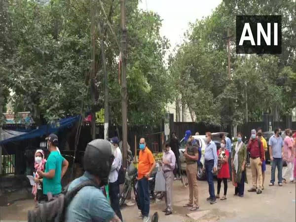 Visual of people standing outside vaccination centre in UP. (Photo/ANI)