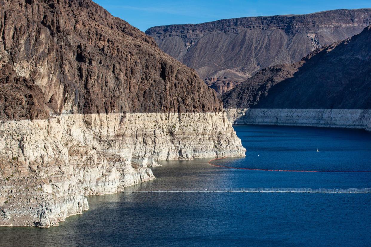 <span class="caption">The white 'bathtub ring' around Lake Mead, shown on Jan. 11, 2022, is roughly 160 feet high and reflects falling water levels.</span> <span class="attribution"><a class="link " href="https://www.gettyimages.com/detail/news-photo/bathtub-ring-caused-by-the-drought-has-formed-in-the-news-photo/1365689217" rel="nofollow noopener" target="_blank" data-ylk="slk:George Rose/Getty Images;elm:context_link;itc:0;sec:content-canvas">George Rose/Getty Images</a></span>