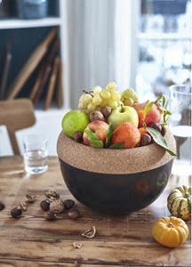 The upper level, made of cork, serves as a fruit bowl. The lower level, made of ceramic, acts as a mini pantry to store potatoes,  onions, beets and other root vegetables, as well as fruit that is not ripe enough. The natural properties of the cork help preserve the fruit and  help keep pesky fruit flies at bay. The ceramic body keeps the light out while the holes in the bowl allow for air circulation. The ceramic body and the insulating properties of the cork lid maintain a constant temperature, much like in an old-school cellar.