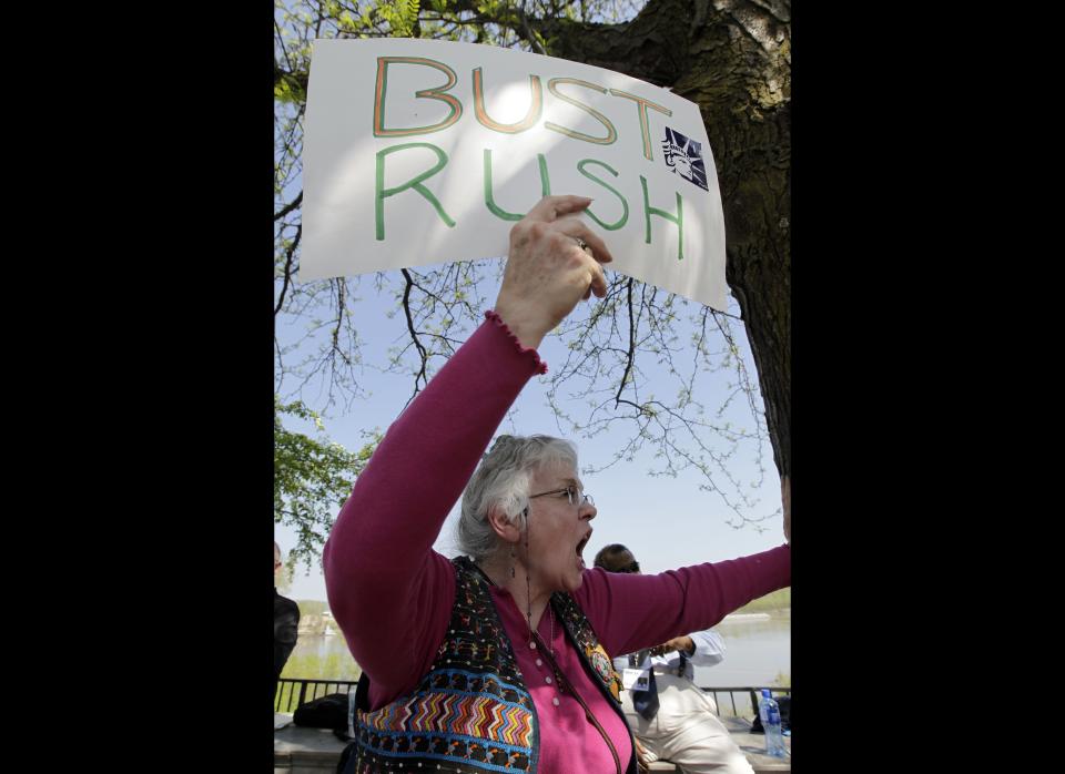 Shelia Rekdal holds a sign during a protest of Rush Limbaugh Wednesday, March 28, 2012, in Jefferson City, Mo. The protesters delivered 35,000 petition signatures Wednesday to the House speaker's office opposing the inclusion of conservative talk show host Rush Limbaugh in the Hall of Famous Missourians in the latest in a series of opposition efforts to Limbaugh's selection. (AP Photo/Jeff Roberson)