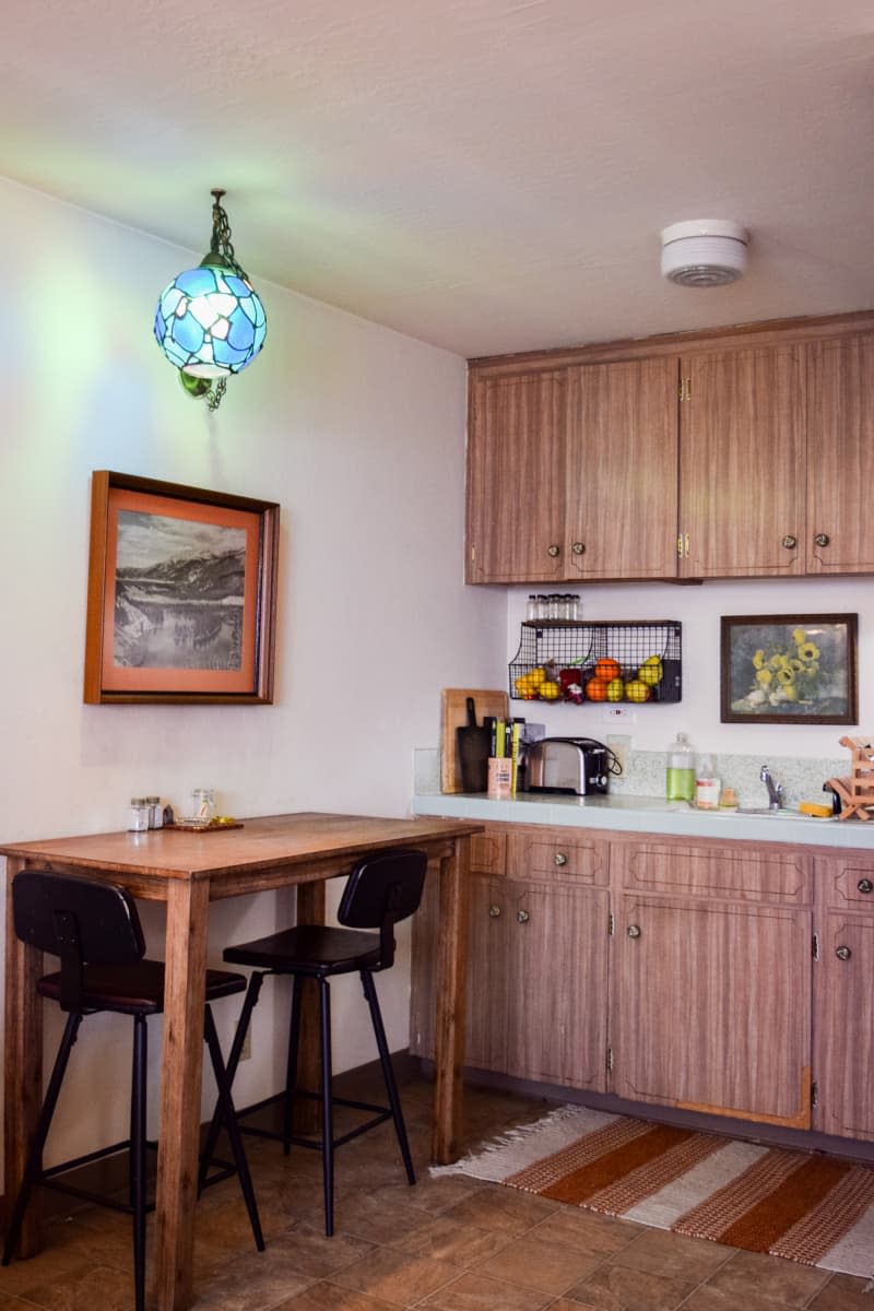 Kitchen with wooden panel cabinets and small breakfast table.