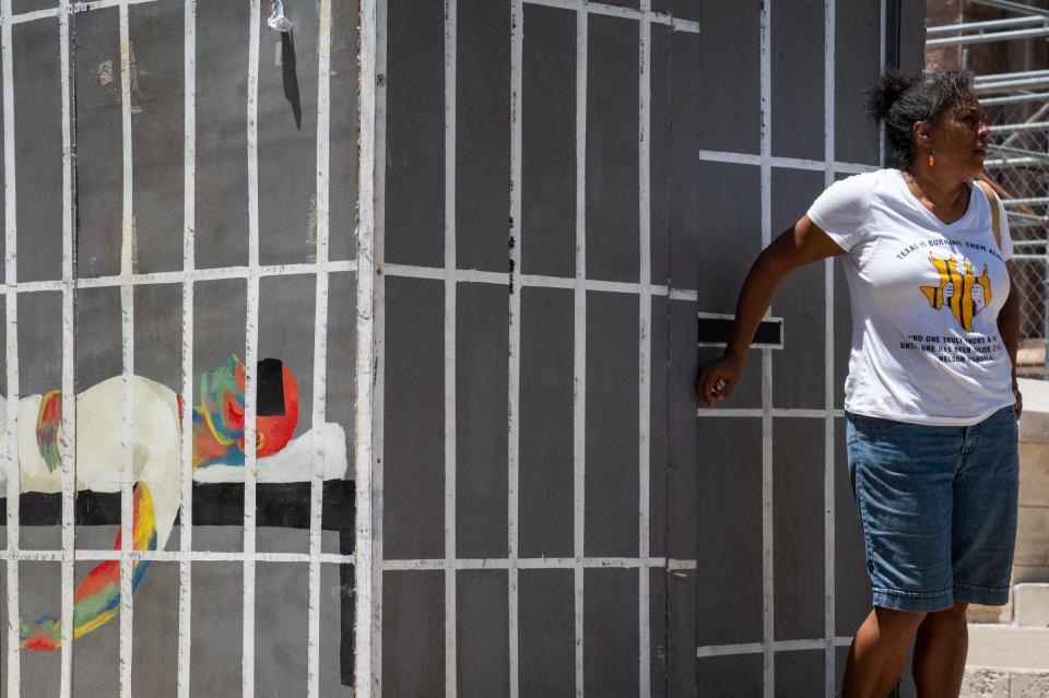 President and Founder of Texas Prisons Community Advocates Amite Dominick stands near the door of a mock prison cell set up near the south steps of the Texas State Capitol in Austin, July 18, 2023. Passers-by could take the 7 Minute Challenge to experience prison conditions inside the cell, with temperatures near 120 degrees, for seven minutes.