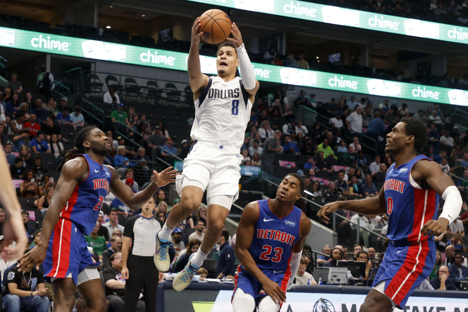 Dallas Mavericks guard Josh Green (8) goes to the basket in front of Detroit Pistons center Isaiah Stewart, left, guard Jaden Ivey (23) and center Jalen Duren (0) during the second half of an NBA preseason basketball game in Dallas, Friday, Oct. 20, 2023. (AP Photo/Michael Ainsworth)