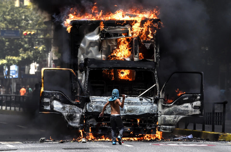 A truck set ablaze by opposition activists blocks a street on July 18.