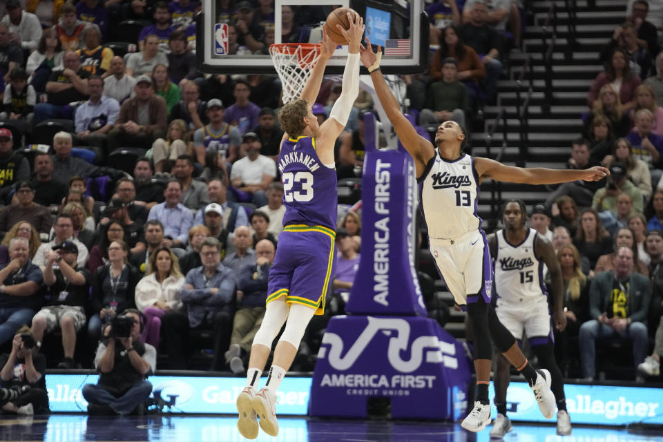 Sacramento Kings forward Keegan Murray (13) and Utah Jazz forward Lauri Markkanen (23) reach for the ball during the first half of an NBA basketball game Wednesday, Oct. 25, 2023, in Salt Lake City. (AP Photo/Rick Bowmer)