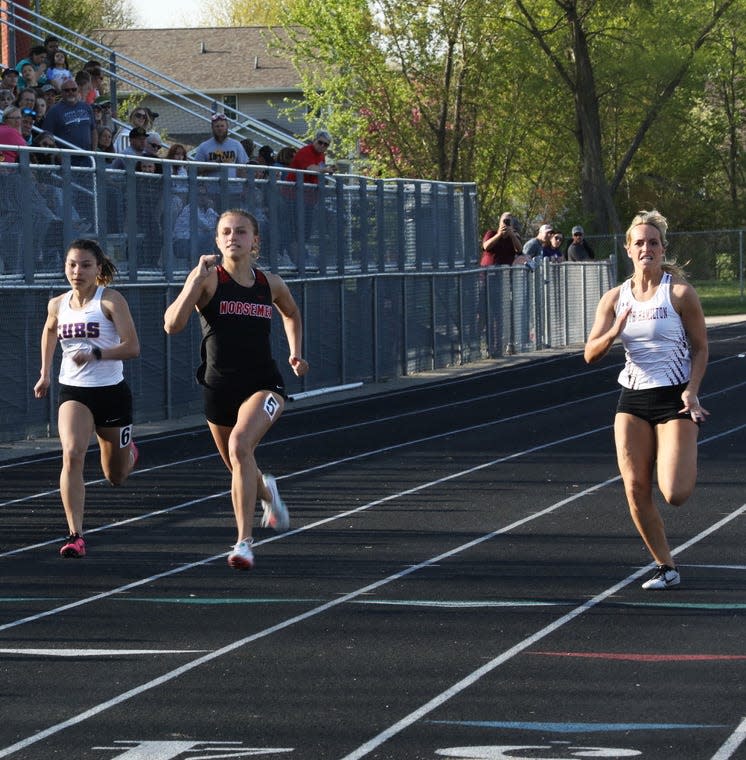 Roland-Story's Kamryn Lande (center) beats out Nevada's Stefany Riera Ramones (left) and South Hamilton's Kate Barkema for first in the girls 100-meter dash at the HOIC co-ed track meet May 4 at Saydel High School in Des Moines.