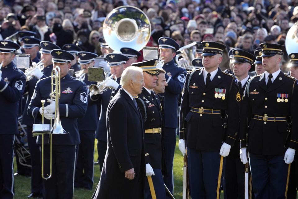 President Joe Biden and French President Emmanuel Macron review the troops with Col. David Rowland, commander of the 3rd U.S. Infantry Regiment, The Old Guard, during a State Arrival Ceremony on the South Lawn of the White House in Washington, Thursday, Dec. 1, 2022. (AP Photo/Alex Brandon)