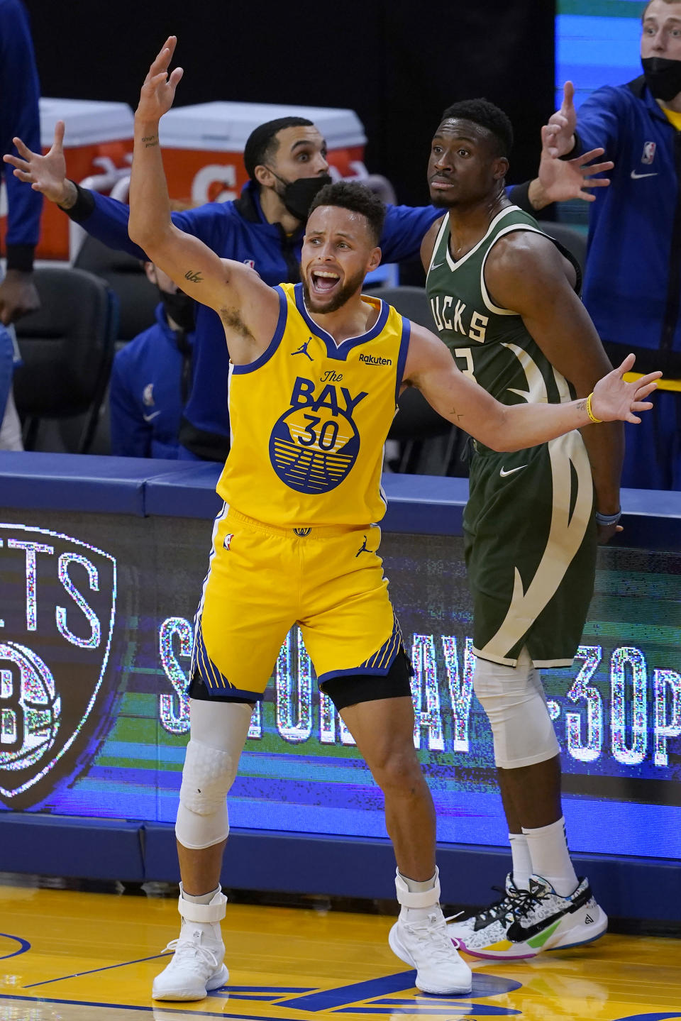 Golden State Warriors guard Stephen Curry (30) reacts after being fouled by Milwaukee Bucks forward Thanasis Antetokounmpo, rear, during the second half of an NBA basketball game in San Francisco, Tuesday, April 6, 2021. (AP Photo/Jeff Chiu)