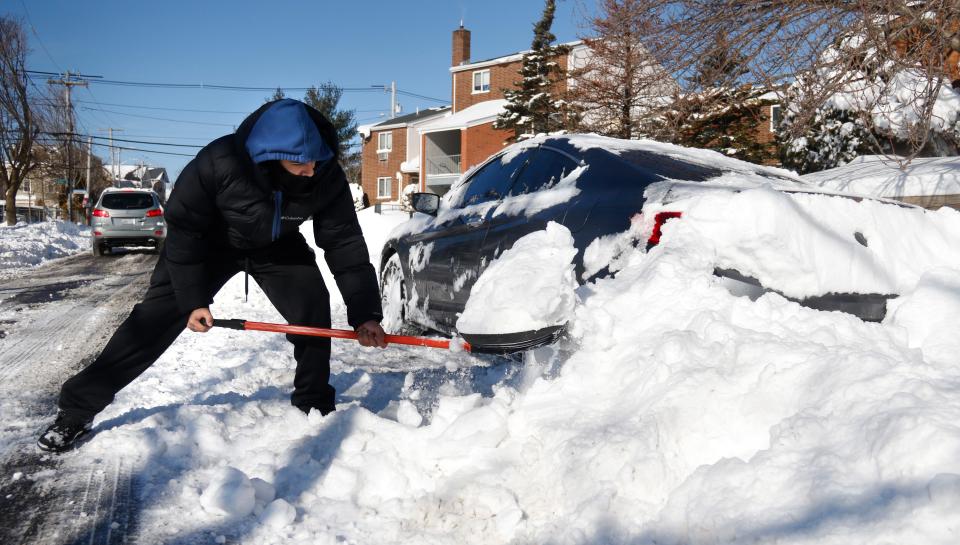 Jose Rodriguez shovels out his plow-buried car in Providence after a blizzard covered the state last January.