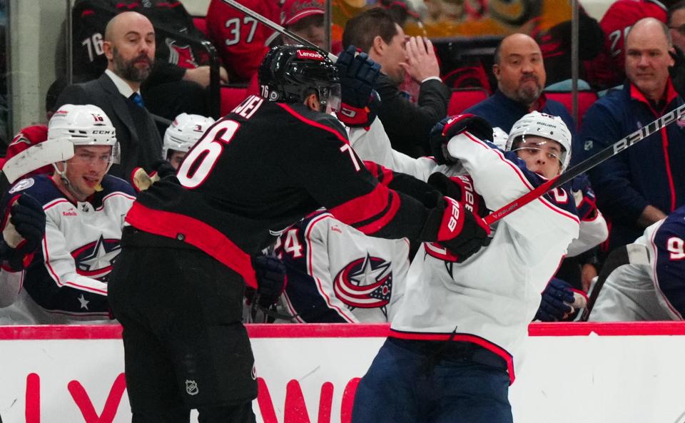 Apr 7, 2024; Raleigh, North Carolina, USA; Carolina Hurricanes defenseman Brady Skjei (76) checks Columbus Blue Jackets left wing Mikael Pyyhtia (82) during the second period at PNC Arena. Mandatory Credit: James Guillory-USA TODAY Sports