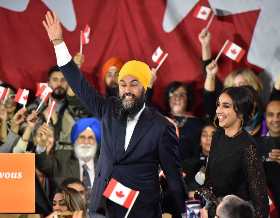 NDP leader Jagmeet Singh and his wife Gurkiran Kaur step on stage under the cheers of his supporters at the NDP Election Night Party in Burnaby BC, Canada, on October 21, 2019. - Prime Minister Justin Trudeau's Liberal Party held onto power in a nail-biter of a Canadian general election on Monday, but as a weakened minority government.
Television projections declared the Liberals winners or leading in 157 of the nation's 338 electoral districts, versus 121 for his main rival Andrew Scheer and the Conservatives, after polling stations across six time zones closed. NDP Leader Jagmeet Singh failed to gain seats for the party. (Photo by Don MacKinnon / AFP) (Photo by DON MACKINNON/AFP via Getty Images)