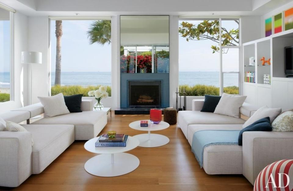 Abigail Turin of the design studio Kallos Turin oversaw the dramatic renovation of her family’s <a rel="nofollow noopener" href="https://www.architecturaldigest.com/story/abigail-turin-santa-barbara-california-beach-house-article?mbid=synd_yahoo_rss" target="_blank" data-ylk="slk:oceanfront retreat in Carpinteria, California;elm:context_link;itc:0;sec:content-canvas" class="link ">oceanfront retreat in Carpinteria, California</a>. B&B Italia sofas are grouped with Cappellini tables in the living room; the floor lamp is by Flos, the throw is by Hermès, and the walls are painted in Benjamin Moore’s Chantilly Lace.