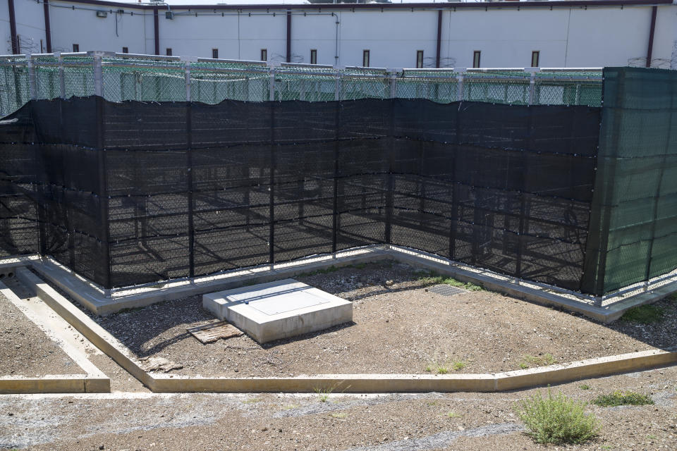 FILE - In this photo reviewed by U.S. military officials, the outdoor recreation area of the Camp V detention facility is seen, on April 17, 2019, in Guantanamo Bay Naval Base, Cuba. The Biden administration has been quietly laying the groundwork to release prisoners from the Guantanamo Bay detention center and at least move closer to being able to shut it down. (AP Photo/Alex Brandon, File)