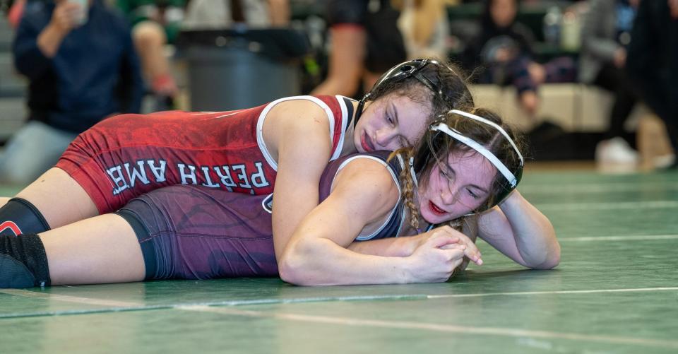 Newton's Gianna Simeone (maroon/black) beats Perth Amboy's Leeah Gutierrez (red/white) in the 107 weight class final at the 2022 East Brunswick Lady Bear Invitational Tournament on Dec. 30 at the Churchill Junior High School gymnasium in East Brunswick.