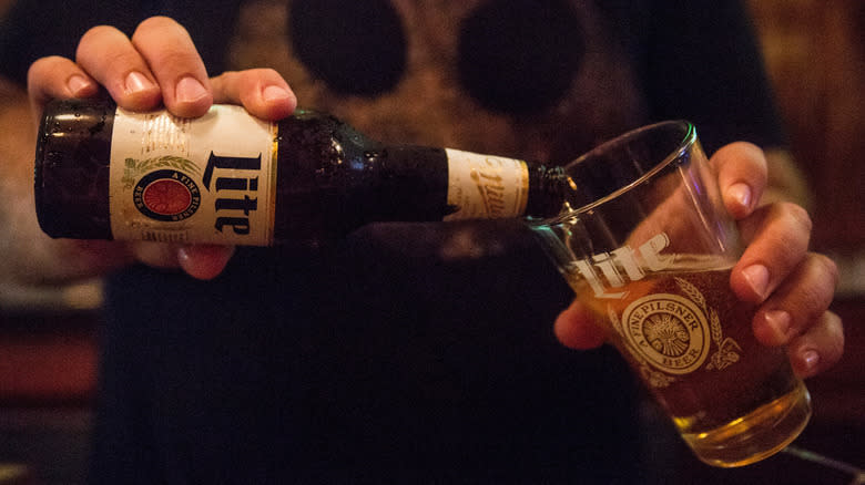 Person pouring a Miller High Life beer