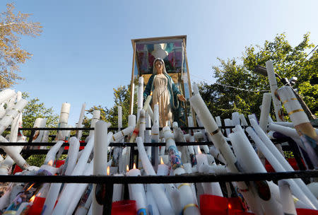 Candles lit by Roma and non-Roma pilgrims in front of a statue of the Virgin Mary near the chapel in Csatka, Hungary on September 9, 2017. REUTERS/Laszlo Balogh