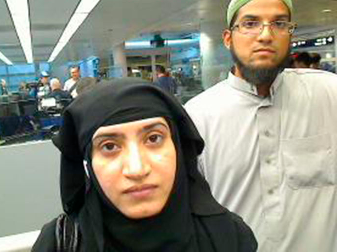 Tashfeen Malik, (L), and Syed Farook are pictured passing through Chicago's O'Hare International Airport in this July 27, 2014 handout photo obtained by Reuters December 8, 2015.   REUTERS/US Customs and Border Protection/Handout via Reuters