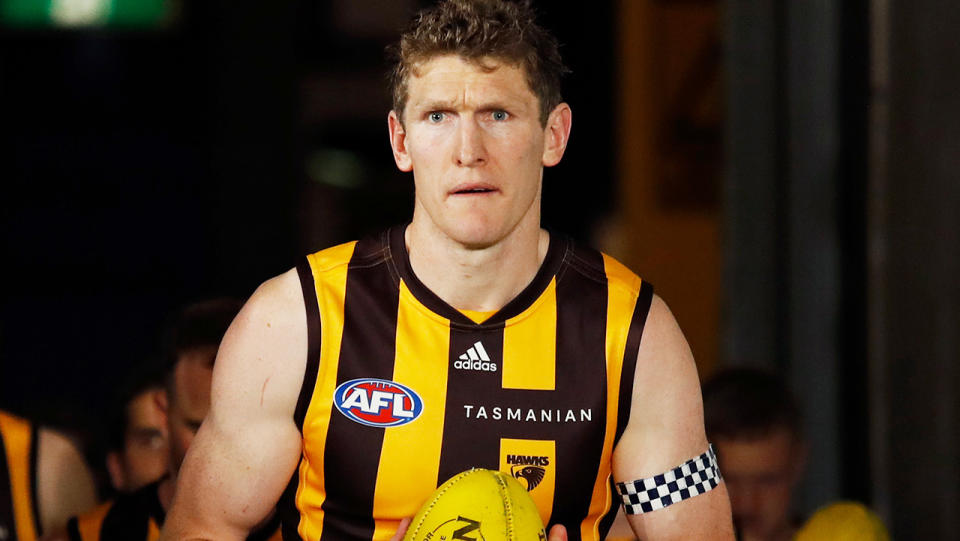 Ben McEvoy leads Hawthorn onto the ground for an AFL match.