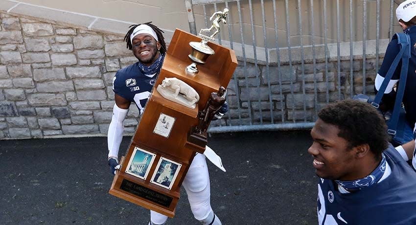 Dec 12, 2020; University Park, Pennsylvania, USA; Penn State Nittany Lions wide receiver Benjamin Wilson (84) carries the Land-Grant trophy. Penn State defeated Michigan State 39-24.