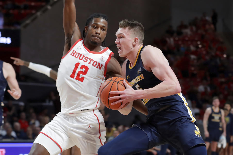 Northern Colorado guard Dalton Knecht, right, drives around Houston guard Tramon Mark (12) during the first half of an NCAA college basketball game Monday, Nov. 7, 2022, in Houston. (AP Photo/Michael Wyke)