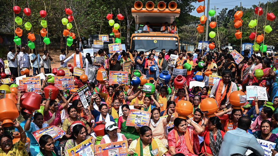 Activists and BJP members hold empty water pots during a protest against the state government over the severe water crisis, in Bengaluru on March 12, 2024. - Idress Mohammed/AFP/Getty Images