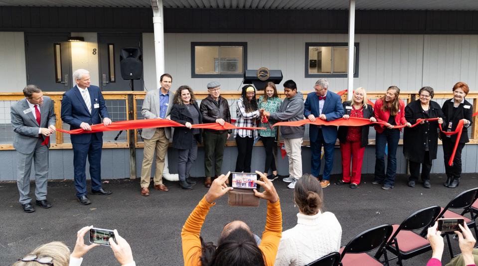 Community members, students and staff cut the ribbon on Oct. 16, the opening day of the school-based wellness center at Erwin Middle