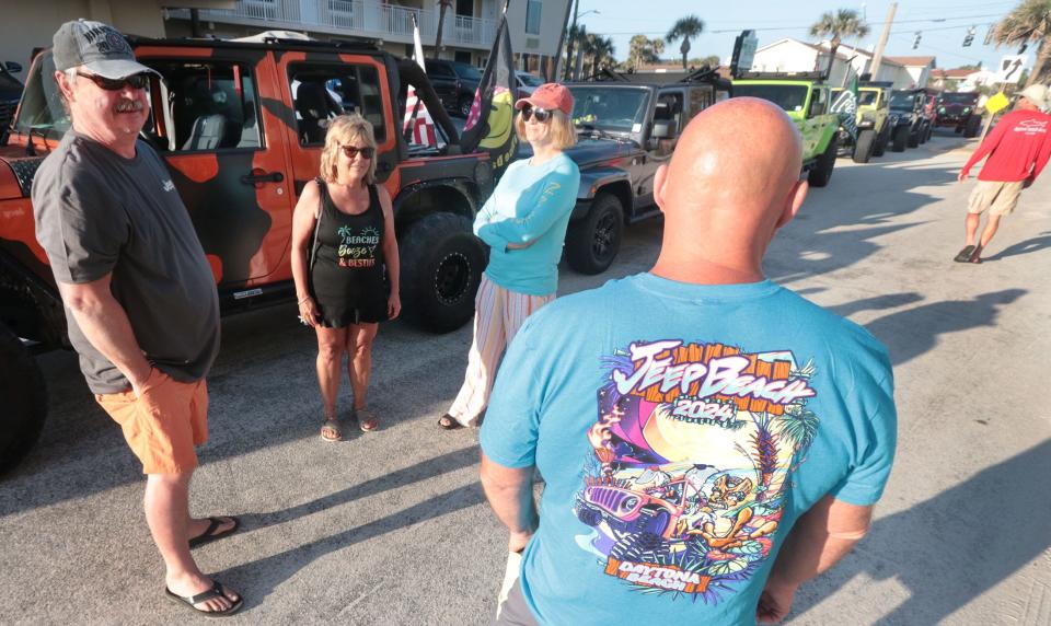 Jeep owners John Geisinger and Brent Clevenger talk with other brand loyalists at the University Boulevard beach ramp as they wait out an early-morning high tide that delayed access to the Jeeps At the Rock event at Hard Rock Hotel. The two-day Hard Rock event, which continues on Thursday, is part of the 10-day Jeep beach celebration in Daytona Beach.