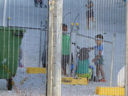 An undated supplied image from Amnesty International claiming to show children playing near a fence at the country's Australian-run detention centre on the Pacific island nation of Nauru. Amnesty International/Handout via REUTERS