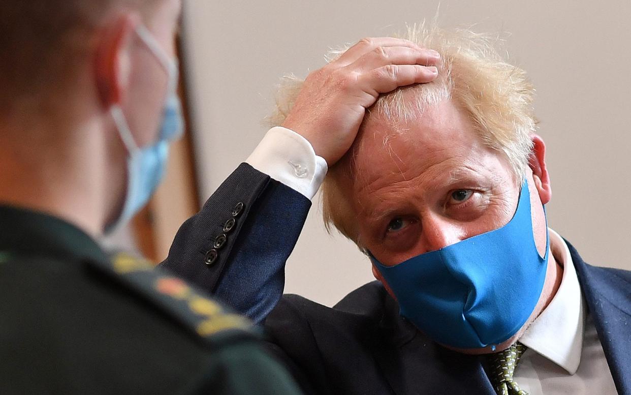 Prime Minister Boris Johnson wears a face mask during a visit to the Ambulance Company in central London - WPA Pool/Getty Images