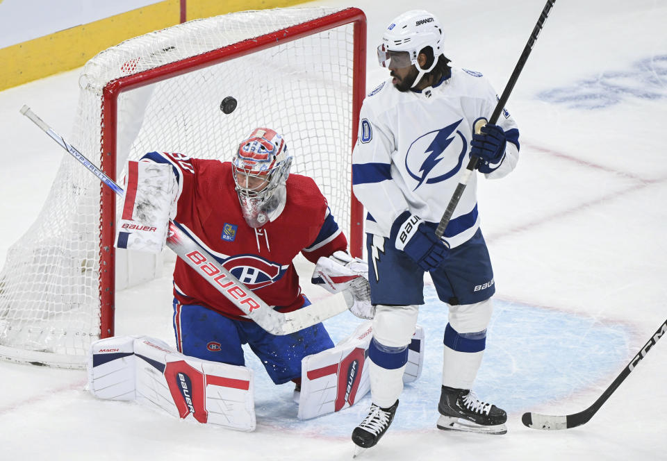 Montreal Canadiens goaltender Cayden Primeau gives up a goal to Tampa Bay Lightning's Brandon Hagel, not seen, as Lightning's Anthony Duclair watches during the second period of an NHL hockey game in Montreal, Thursday, April 4, 2024. (Graham Hughes/The Canadian Press via AP)