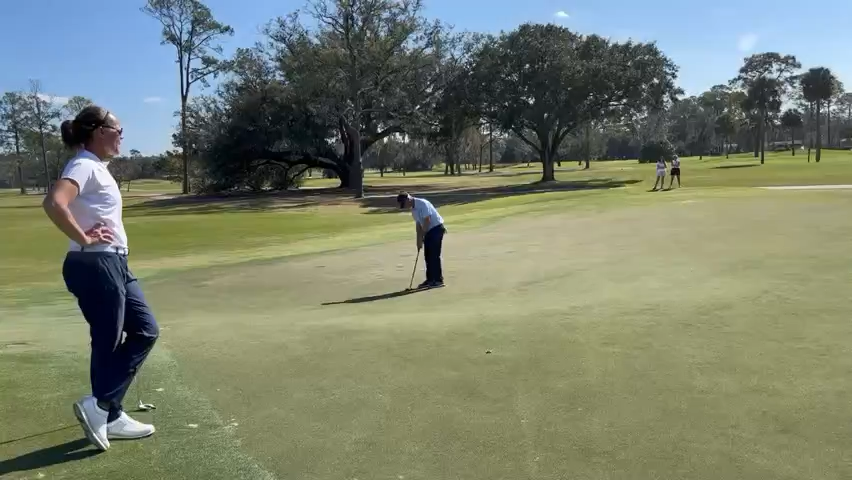 Hayes Farley lags a putt on the 18th hole of the San Jose Country Club during an Underwood Cup Four-Ball match. Watching is playing partner Jennifer Borocz.