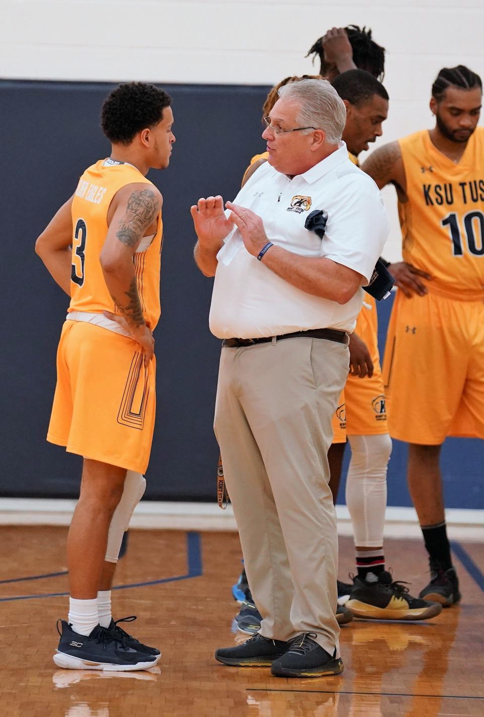 Jordan Stevens and Coach Richard Tharp strategize on-court during the halftime break.