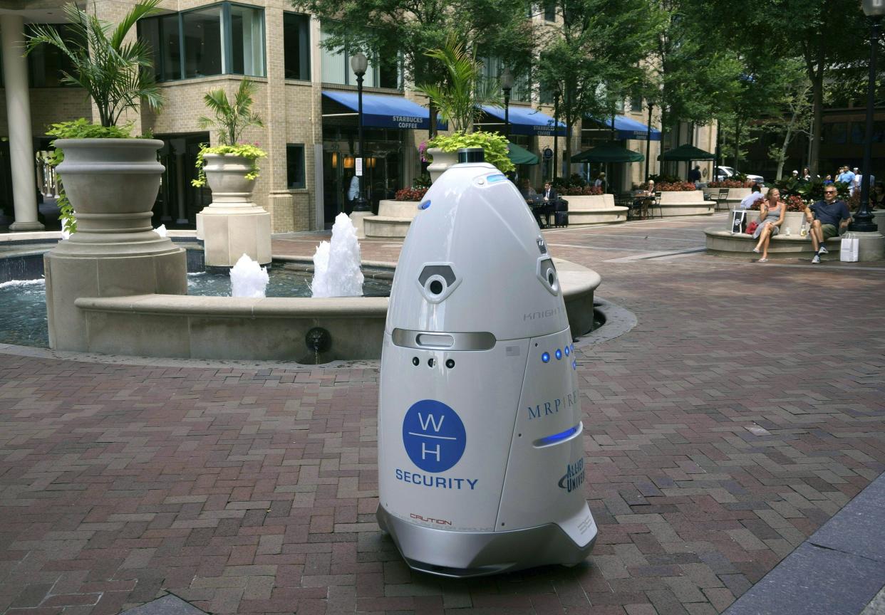 A five-foot (1.5 meter) tall outdoor K5 security robot patrols the grounds of the Washington Harbour retail-residential center in the Georgetown district of Washington, DC July 26, 2017. The robots, produced by the California tech company Knightscope, are intended to assist in crime prevention and law enforcement. They are equipped with a 360-degree camera, thermal imaging, automatic license plate recognition, directional microphones, proximity sensors and other technology. Their "anomaly detection software" is designed to determine if there is a threat, and alert appropriate authorities.