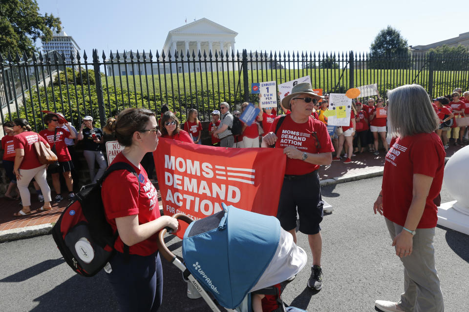 Moms Demanding Action line up during a rally at the State Capitol in Richmond, Va., Tuesday, July 9, 2019. Governor Northam called a special session of the General Assembly to consider gun legislation in light of the Virginia Beach Shootings. (AP Photo/Steve Helber)