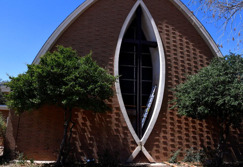 A ladder rests within the fish-shaped window of the former Brook Hollow Christian Church on April 7. The sanctuary interior is being remodeled.