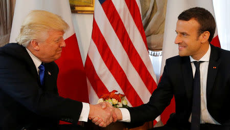 U.S. President Donald Trump (L) and French President Emmanuel Macron shake hands before a working lunch ahead of a NATO Summit in Brussels, Belgium, May 25, 2017. REUTERS/Jonathan Ernst