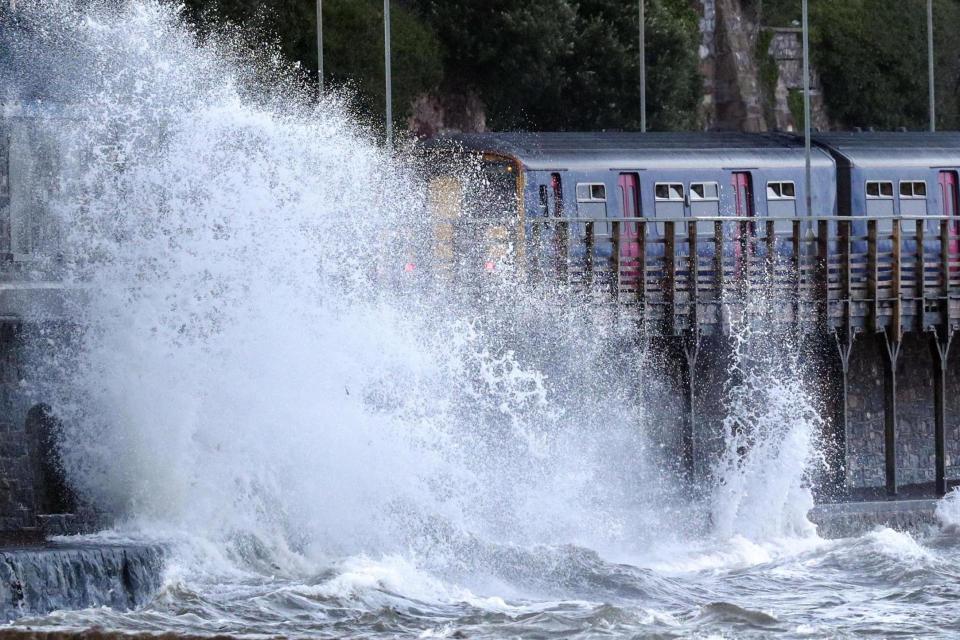 Waves hitting the Devon coast on Friday (PA)