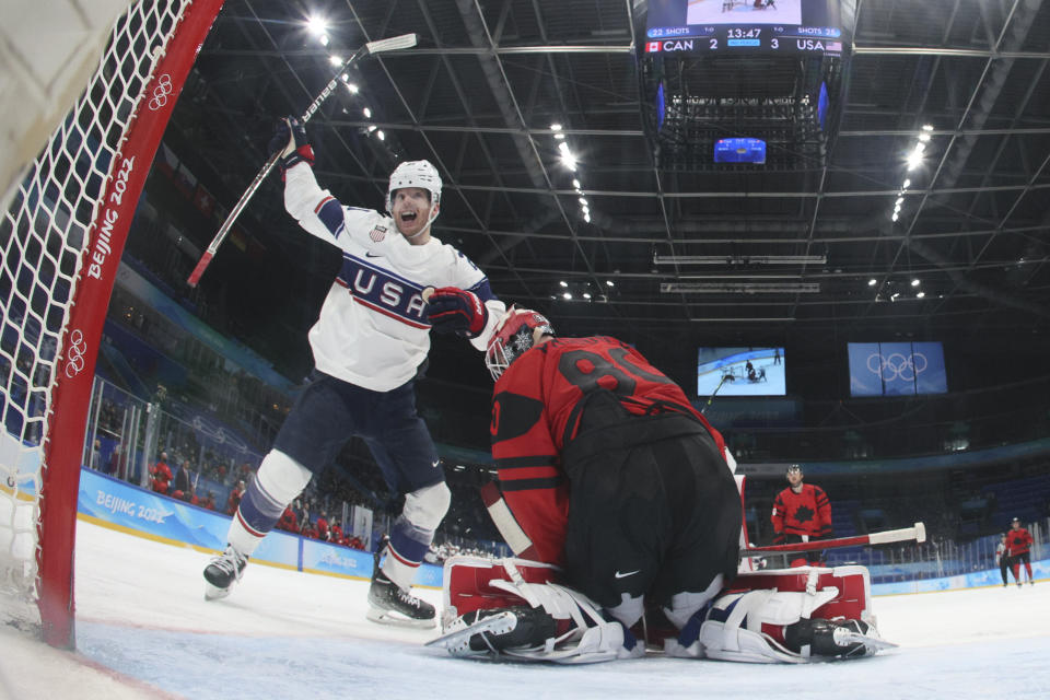 United States' Brian O'Neill (21) celebrates after teammate Kenny Agostino scored a goal against Canada goalkeeper Eddie Pasquale (80) during a preliminary round men's hockey game at the 2022 Winter Olympics, Saturday, Feb. 12, 2022, in Beijing. (Bruce Bennett/Pool Photo via AP)