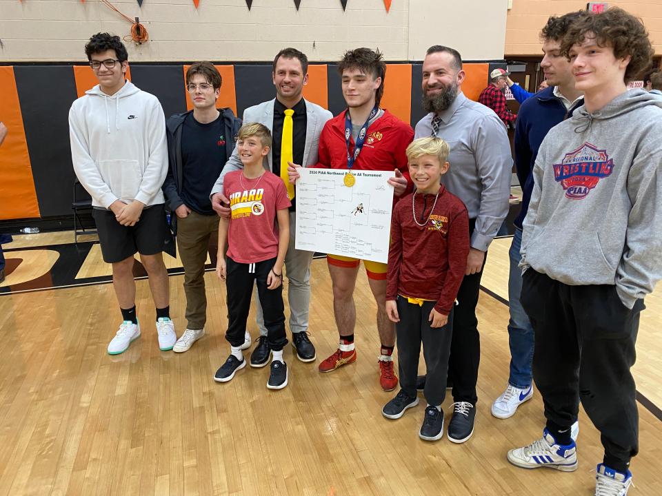 Girard’s Story Buchanan (center) celebrates his 160-pound championship Saturday at the Class 2A Northwest regional wrestling championships.