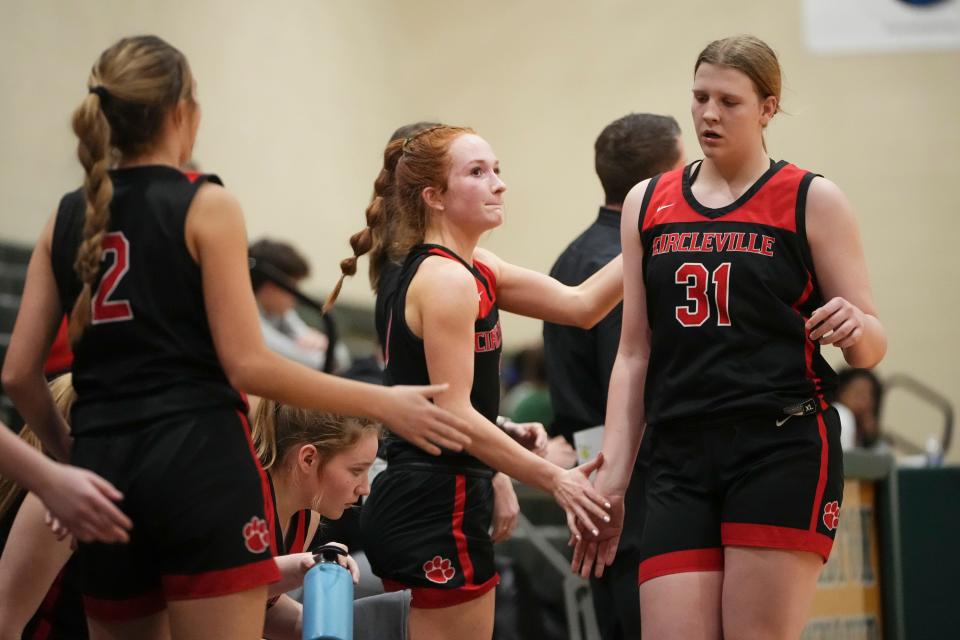 Circleville’s Addison Edgington heads to the bench and is greeted by Faith Yancey in the final minutes of a 66-37 win at Hamilton Township on Jan. 23.