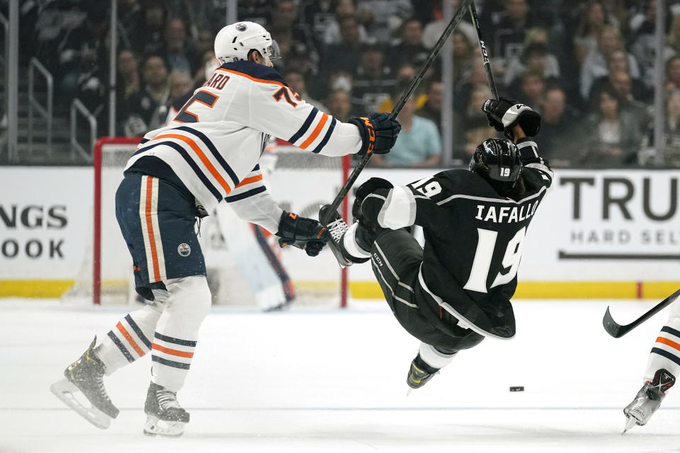 Los Angeles Kings left wing Alex Iafallo, right, is upended by Edmonton Oilers defenseman Evan Bouchard during the first period in Game 3 of an NHL hockey Stanley Cup first-round playoff series Friday, May 6, 2022, in Los Angeles. (AP Photo/Mark J. Terrill)